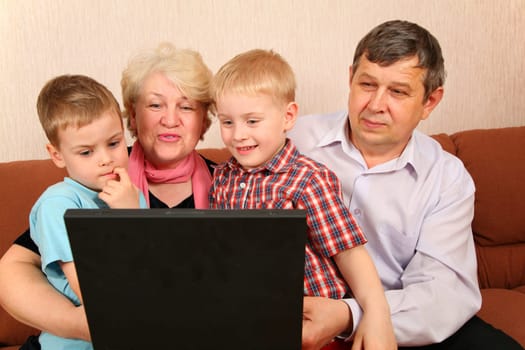 grandparents with grandchildren with notebook