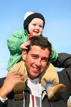 baby on father's shoulders