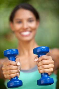 Young woman exercising in outdoor setting. Vertically framed shot.