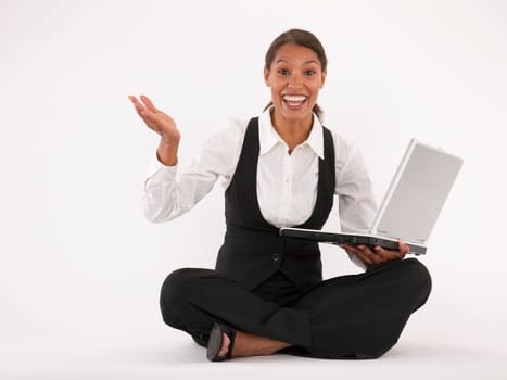Young woman sitting on floor using laptop. Horizontally format.