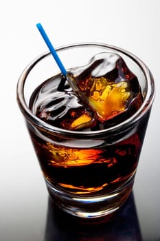 Black Russian mixed drink on a grey background with reflection