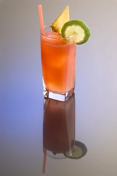 Bay Breeze mixed drink with garnish on plain background with reflection