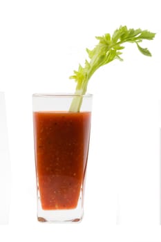 Bloody Mary mixed drink with celery garnish on white background