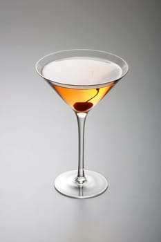 Rob Roy or Manhattan mixed drink with cherry garnish on grey background
