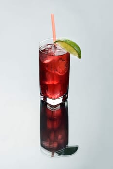 Cape Codder mixed drink on a grey background with reflection