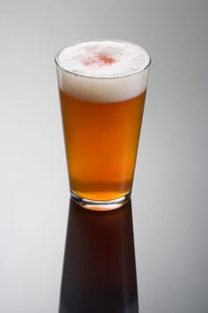 Snake Bite Jack mixed drink on grey background with reflection