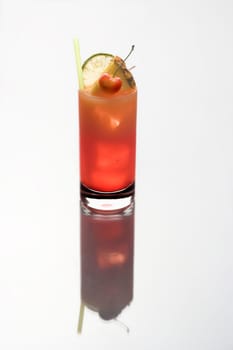 Mai Tai mixed drink with fruit garnish on a plain white background with reflection