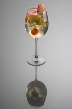 Glass of white sangria on grey background