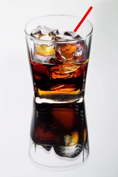 Black Russian mixed drink on a grey background with reflection