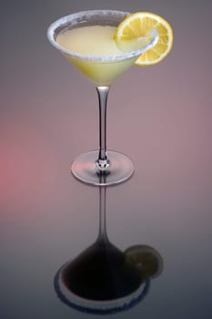 Sidecar cocktail with orange garnish on grey background