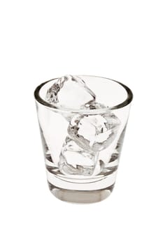 Empty old fashioned glass with ice cubes on a white background on a white background