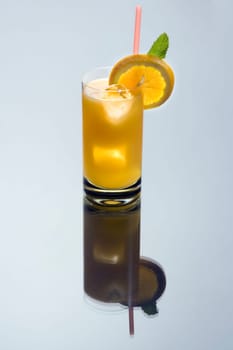 Screwdriver Cocktail with orange slice garnish on grey background