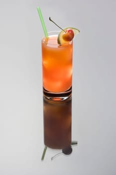 Seabreeze mixed drink with lime and cherry garnish on a grey background