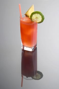 Bay Breeze mixed drink with garnish on plain background with reflection