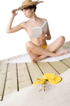 Beach - starfish with flip-flop on sand, woman in background