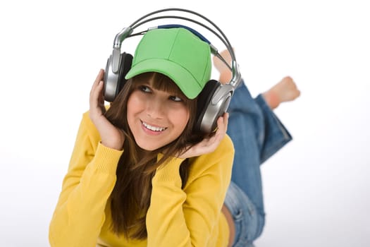 Happy female teenager enjoy music with headphones