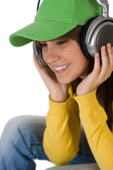 Happy female teenager enjoy music with headphones