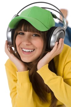 Happy female teenager enjoy music with headphones