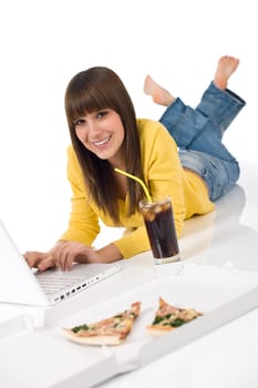 Happy female teenager with laptop lying down