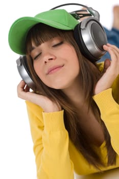 Happy female teenager enjoy music with headphones