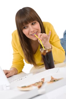 Happy female teenager with laptop lying down