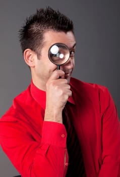 Funny businessman with magnifying glass
