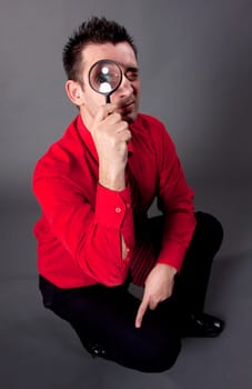 Funny businessman with magnifying glass