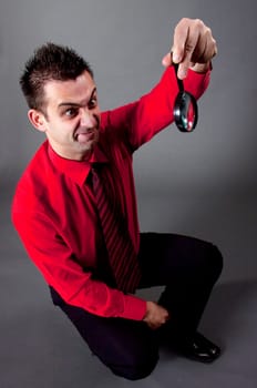 Funny businessman with magnifying glass