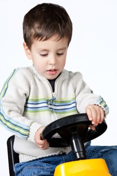 Boy driving a toy car