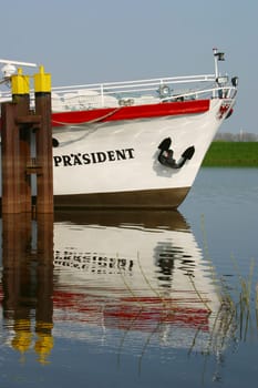 Excursion boat reflected in the water