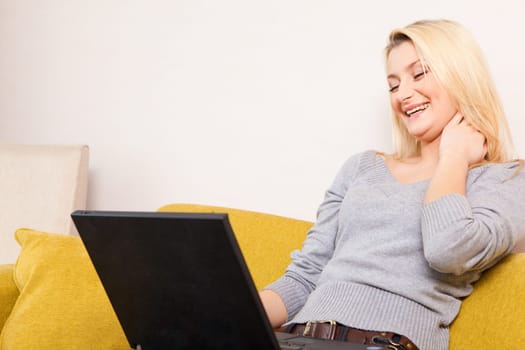 woman sitting on sofa and having coffee