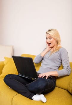 woman sitting on sofa and having coffee