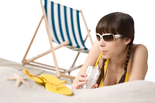 Beach - Woman in bikini with drink and flip-flop on sand