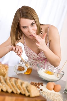 Baking - Happy woman tasting healthy ingredient