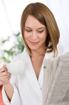Breakfast - happy woman reading newspaper drink coffee