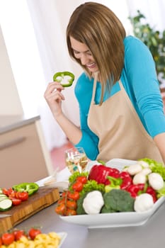 Cooking - Smiling woman reading recipe from cookbook