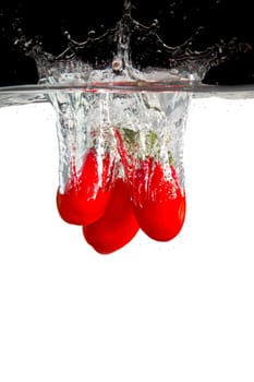 Three Roma tomatoes in water