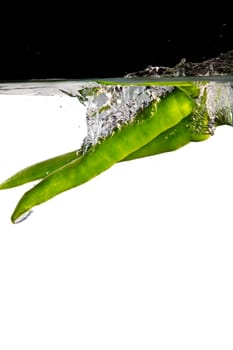 Green hot peppers in water