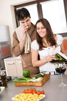 Cooking - happy couple together in modern kitchen
