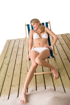 Beach - Woman in bikini sunbathing on deck chair
