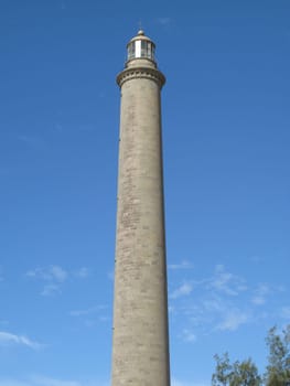 Tall narrow gray lighthouse