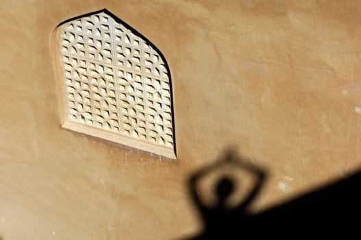 Shadow play at the ornamental window,Oman