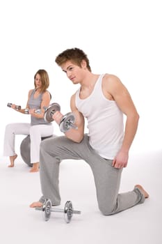 Fitness - Young couple exercise with weights