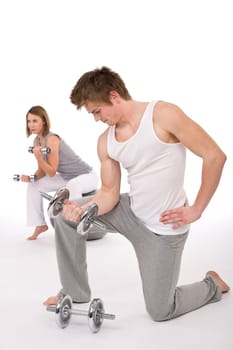 Fitness - Young couple exercise with weights