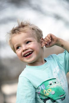 Blonde boy sticks his tongue out