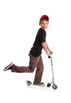 Child riding a scooter and smiling