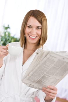 Breakfast - happy woman reading newspaper drink coffee