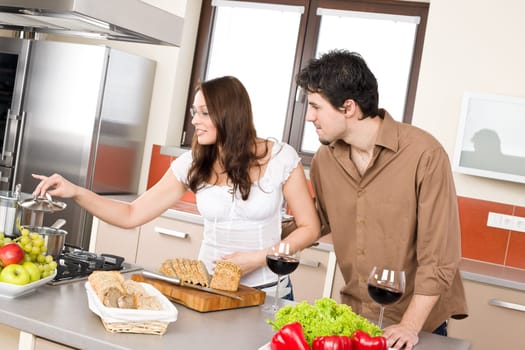 Cooking - happy couple together in modern kitchen