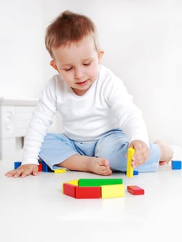 Lovely boy playing with blocks