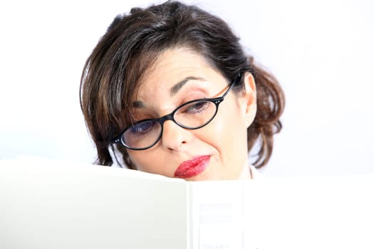 A young woman hides behind a folder